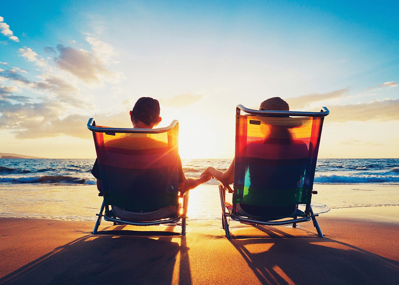 Couple on beach watching sunset